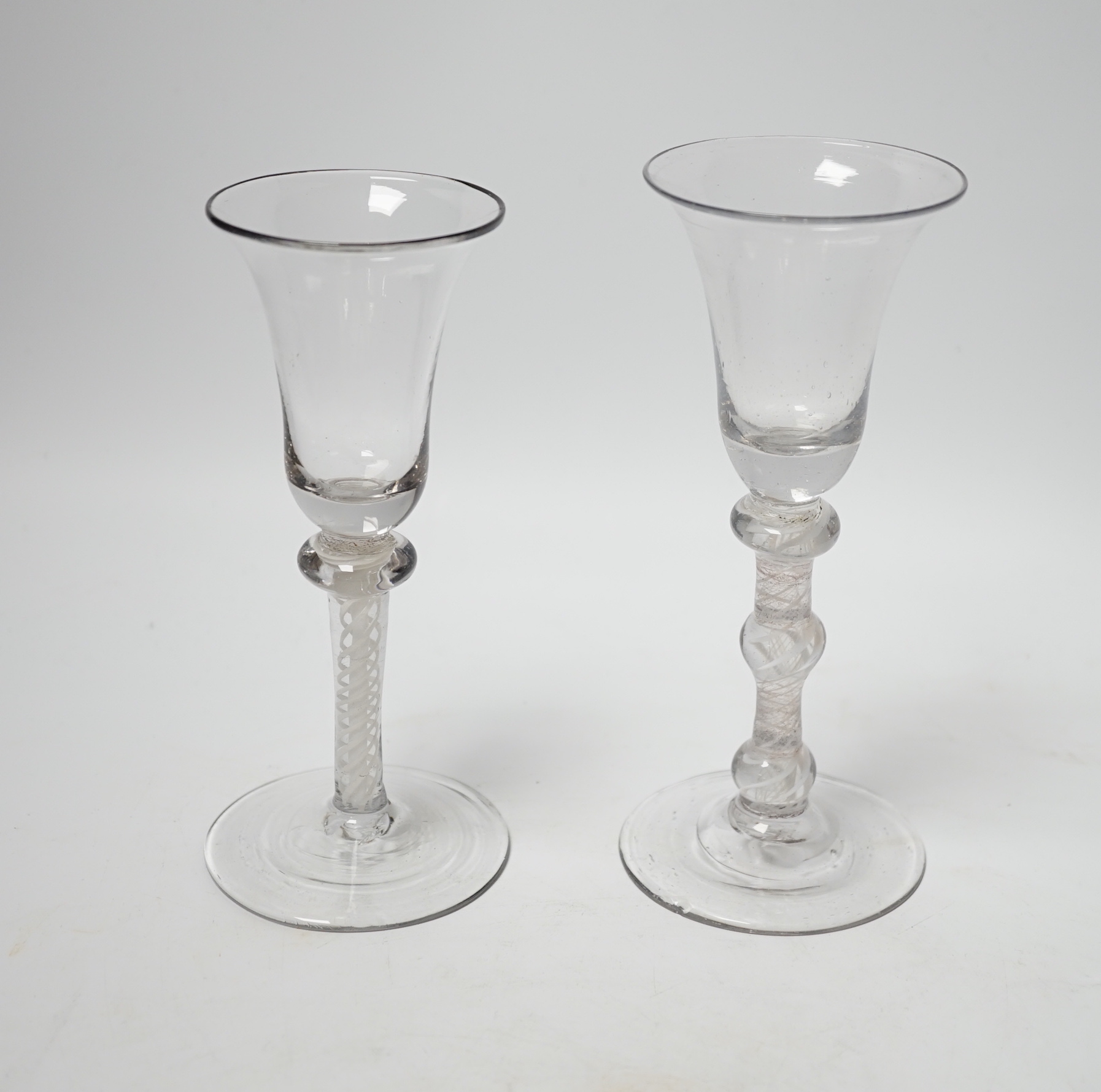 Two Dutch DSOT stem glasses, with bell-shaped bowls, one with three knops, the other with one knop at the top of the stem, tallest 17cm